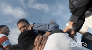 TV gif. Characters from The New Edition story engage in a fight. One man holds another man to the ground by the shirt collar, and three other men try to break up the confrontation.