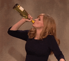SNL gif. Jessica Chastain chugs down a bottle of wine and grimaces in pain after gulping it down.