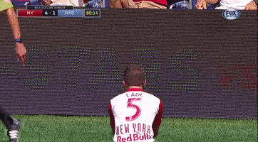 Sports gif. Connor Lade on the New York Red Bulls walks on the field and pauses. He turns around to face us and reveals the shock and dismay on his face. He holds his arms out in confusion and he walks off still dumbfounded by what happened. 