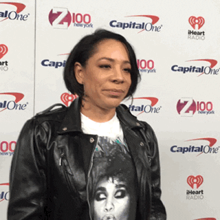 Celebrity gif. Selenis Leyva is being interviewed on the red carpet but she hears a question she doesn't like. She puts a hand up to stop the interviewer and turns back to stare them down.