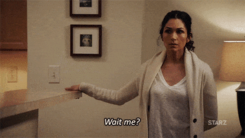 TV gif. Lela Loren as Angela in Power. She's at home and wearing comfy home clothes and walks towards us looking baffled as she points to herself and says, "Wait, me?"