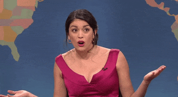 SNL gif. Cecily Strong as the girl you wish you hadn't started a conversation with at a party looks at us, shrugging. Her mouth is open and she shakes her head in confusion.  