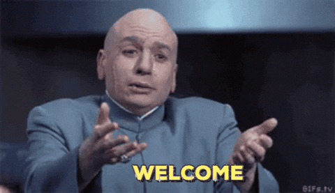 Movie gif. Mike Myers as Dr. Evil from Austin Powers reaches out his arms, as if to welcome someone into a hug. Text, "Welcome."