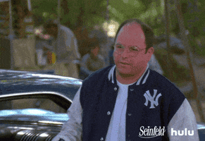 Seinfeld gif. Jason Alexander as George takes a cool stride forward wearing a Yankees bomber jacket, and clicks his tongue as he points his finger at someone.