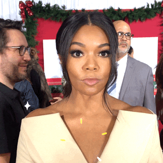 Celebrity gif. Gabrielle Union looks at us with wide eyes and purses her lips as she gives two big thumbs up. Sparkles shimmer around her face.