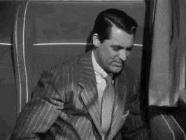 Movie gif. Cary Grant as Johnnie in Suspicion. He looks frustrated as he tries to get comfortable in his seat, putting his hand up to his face before sighing and readjusting his position again.