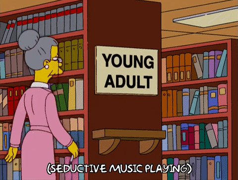 A GIF of a cartoon librarian crossing 'Young' off of a sign that reads 'Young Adult', placing a red light underneath it and hanging a beaded curtain between the shelves