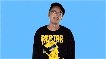 Video gif. Sweater Beats, a musician, looks calm but uncaring as he shrugs his shoulders quickly.