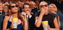 frobz91 entertained eating popcorn GIF