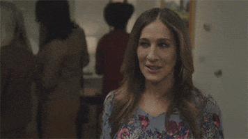 TV gif. Sarah Jessica Parker as Frances in Divorce winces and shrugs her shoulders awkwardly, as if saying "whoops."