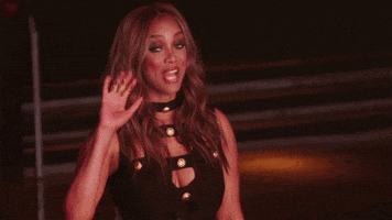 Reality TV gif. On America's Next Top Model, Tyra Banks waves goodbye, blows a kiss and begins to walk away.