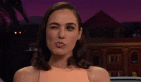 TV gif. Gal Gadot is on the Late Late Show with James Cordon. She winks and makes a kissy face in sync with the wink.