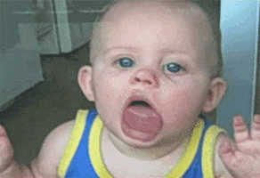 AFV gif. Pressed against the glass, a baby licks a window while staring at us.