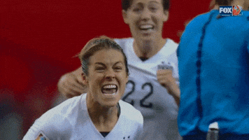 Sports gif. American soccer player Kelley O'Hara screams with a pure sensation of triumph.