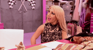 Reality TV gif. Naomi Smalls on RuPaul’s Drag Race Season Eight looks up at someone with a big smile and high fives them.