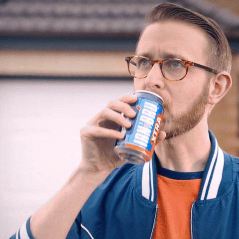 Light skinned man, Caucasian man with oval-shaped glasses sipping a can labeled 'IRN BRU xtra'. Looking satisfied and saying 'unbelievable'.
