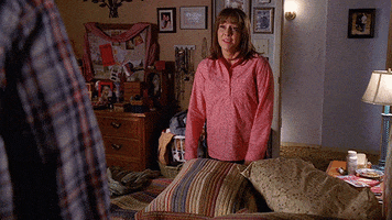 TV gif. Patricia Heaton as Frankie in The Middle. She stands in front of a bed and closes her eyes, exhausted. She flops down, face first onto the bed, and bounces slightly with the impact. 