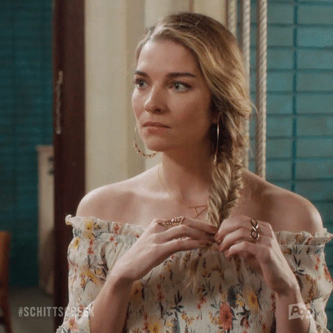 TV gif. Annie Murphy as Alexis Rose from Schitt's Creek fiddles with her fishtail braid and says repulsively, "What?! Eww!"