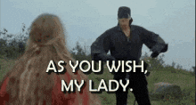 Movie gif. Cary Elwes as Westley in The Princess Bride dressed as the Dread Pirate Roberts bows to the princess and says, "As you wish, my lady."