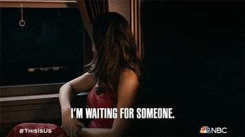 TV gif. Mandy Moore as Rebecca in This Is Us looks despondently out a window in a vintage train car as she says, "I'm waiting for someone."