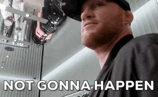 Video gif. Low shot of UFC fighter Justin Gaethje in a baseball cap turning his head to speak to us in a matter of fact way. Text, "Not gonna happen."