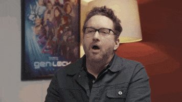 Video gif. Burnie Burns, writer for Rooster Teeth, is sitting in a room and he says, "Really?" with an unbelieving blink.