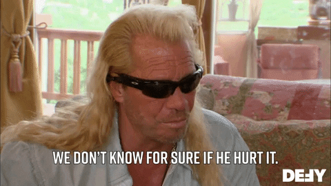 Dog the Bounty Hunter displaying profound emotion, possibly frustration, deep concern, or serious reflection, with a hand gesture.
