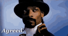 Meme gif. Snoop Dogg nods, in a top hat and cravat, his nods gradually increasing in enthusiasm. Text, “agreed.”