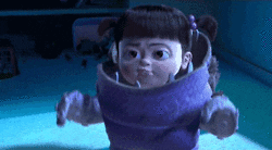 Disney gif. Dressed as a monster, Boo from Monsters Inc. yells, “boo!”