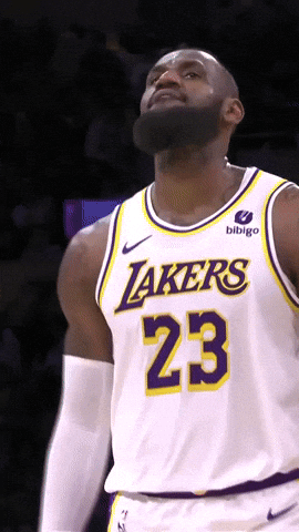 Sports gif. Lebron James wears his Lakers jersey as he walks with a bounce in his step across the court, bobbing his head with an assured expression.