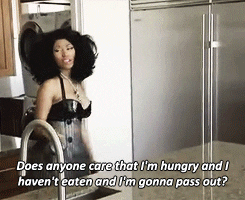 Celebrity gif. Nicki Minaj cools herself with a fan as she says, "Does anyone care that I'm hungry and I haven't eaten and I'm gonna pass out?"