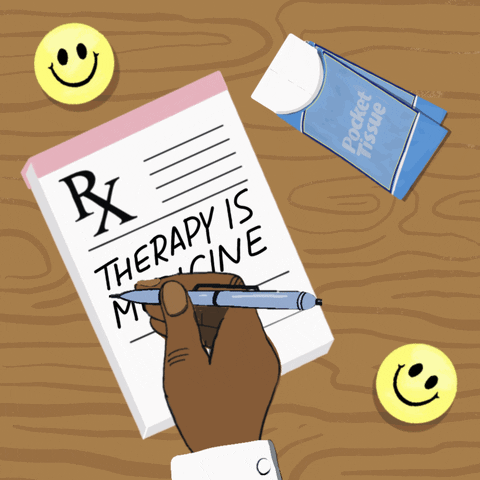 Digital art gif. Animation of a doctor's hand writing on a prescription pad sitting on a wooden table. The text reads, "Therapy is medicine." Next to the pad is a small package of tissues.
