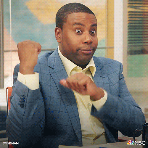 TV gif. Kenan Thompson in Kenan, seated, points both his index fingers across the room, as if he's emphasizing a point.