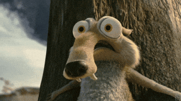 Movie gif. Scrat the squirrel from Ice Age breathes heavily, his eyes bulging as he flattens himself fearfully against a tree trunk.
