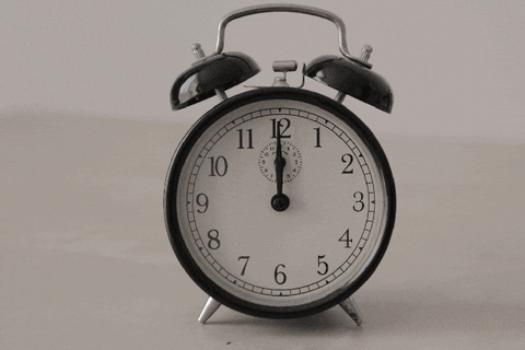 An animated gif of a clock with the hands advancing quickly all the way around.