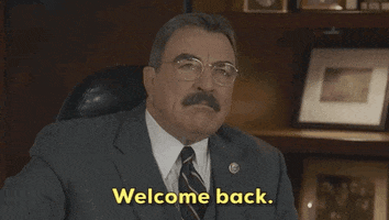 TV gif. Tom Selleck as Frank in Blue Bloods says, "Welcome back," with a smug smile.