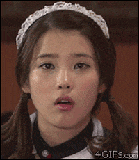 TV gif. IU, also known as Lee Ji-eun, winks and grins on the South Korean show, Heroes.