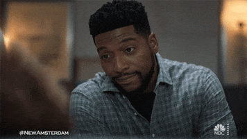 TV gif. Jocko Sims as Dr. Floyd Reynold on New Amsterdam looks at someone with a warm smile.