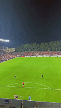Football Flies Out of Stadium Onto Balcony 