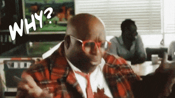 Video gif. Man wearing a red plaid suit coat throws up his hands as he shouts, "Why?"