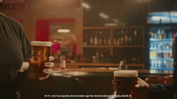 Video gif. Two people in a bar clink full pints of beer in a toast. Text, "Cheers to that!"