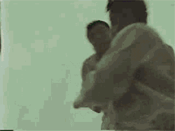 Video gif. Two martial artists fighting. One fighter throws the other forward, and we cut to them falling before hitting the ground and exploding into a comically large fireball.