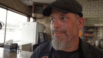Knowing Grin GIF