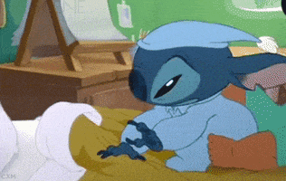Disney gif. Stitch wears blue pajamas and a nightcap. He climbs onto his bed and pulls a turtle plushie from under his pillow. He plops down and lays on the bed, hugging the turtle tight as he tries to fall asleep.