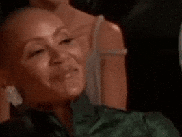 Celebrity gif. Jada Pinkett Smith is sitting at an awards ceremony and she smiles lightly before rolling her eyes heavily, clearly not amused by the joke.
