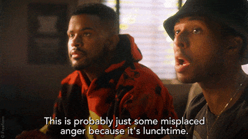 TV gif. Diggy Simmons as Douglas and Trevor Jackson as Aaron in Grownish. They're both sitting on a couch and Douglas holds a hand out to stop someone while saying, "This is probably just some misplaced anger because it's lunchtime."