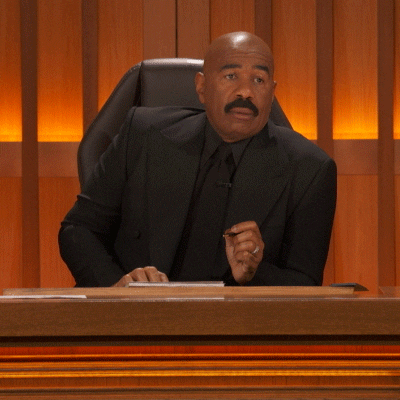 Celebrity gif. Steve Harvey is sitting in his judge seat and abruptly starts cracking up, throwing his mouth open and quickly jotting something down in his notepad.