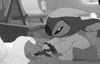 Disney gif. Stitch from Lilo & Stitch in his pajamas and nightcap pulls his doll from under his pillow, snuggles into bed.