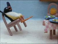 Sponsored gif. Pingu the claymation penguin tilts backward on the back two legs of his chair while looking shocked.