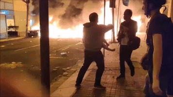 Fearing Spread of Fire Burning During Barcelona Protests, Father Carries Son Into Street
